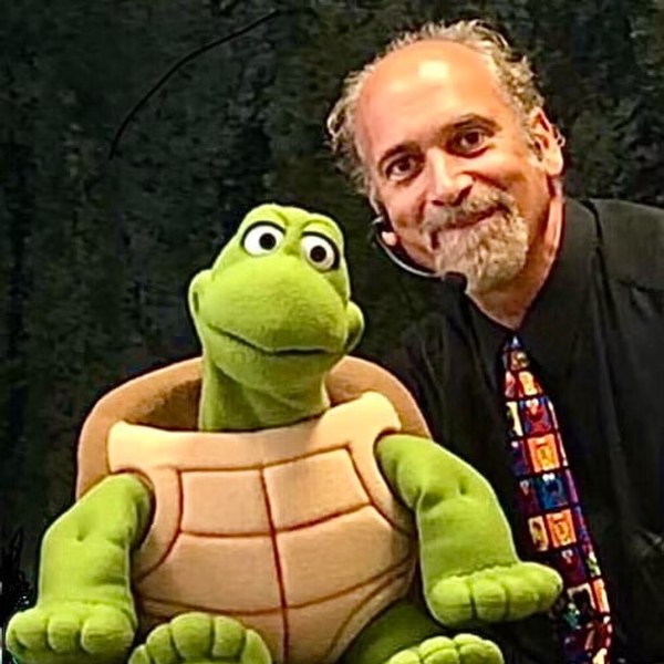 Bob Abdou performing with a turtle puppet