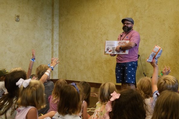 Jimmy Vee reading How to Make Your Sock Talk to a room of children with their hands up